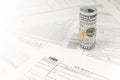 1065 U.S. Return of Parentship Income form with roll of american dollar banknotes