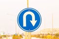 U turn sign blue for motorbike, car side street. Rules for road users. It\'s traffic sign. Royalty Free Stock Photo