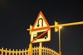 U-turn signs on the street at night Is a grain film image. U turn sign after sunset. View of dark, black sky