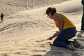 UAE/ABUDHABI - 13 DEZ 2018 - Woman writing in the sand in the desert of Abu Dhabi. UAE