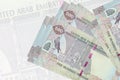 500 UAE dirhams bills lies in stack on background of big semi-transparent banknote. Abstract presentation of national currency Royalty Free Stock Photo