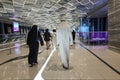 People walk to entrance to Dubai metro station at EXPO 2020. Modern design of underground station Royalty Free Stock Photo