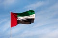 UAE flag waving in the sky, national symbol of UAE. UAE National Day. Royalty Free Stock Photo
