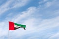 UAE flag waving in the sky, national symbol of UAE. UAE National Day. Royalty Free Stock Photo