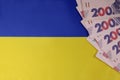 Uah hrn gryvna hryvnia money currency on national ukrainian flag. copy space for text