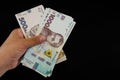 UAH Money of Ukraine 1000 and 500 hryvnia in hand is isolated on a black background. Copy of space. Royalty Free Stock Photo