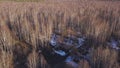 UAV unmanned aerial vehicle drone soaring in the sky above withered forest and city on the background. Clip. Heavy lift