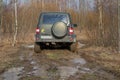 UAZ-Patriot stuck on the road in the mud in the spring woods