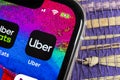 Uber application icon on Apple iPhone X screen close-up. Uber app icon. Uber is taxi car transportation Royalty Free Stock Photo