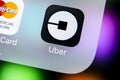 Uber application icon on Apple iPhone X screen close-up. Uber app icon. Uber is taxi car transportation Royalty Free Stock Photo