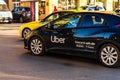 Uber car in traffic at rush hour stopped at red light. Car pollution, traffic jam in the morning and evening in the capital city Royalty Free Stock Photo