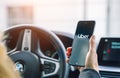 Uber driver holding smartphone in car. Uber is an American company offering different transportation services online Royalty Free Stock Photo