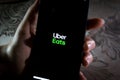 Uber Eats app - A girl using UberEats app on a smartphone to order food online