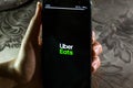 Uber Eats app - A girl using UberEats app on a smartphone to order food online