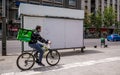 Uber eats courier on a bicycle delivering the order