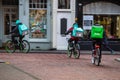 Uber eats and deliveroo delivery persons on bike