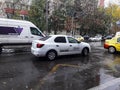 An Uber logo branded car on a street in downtown. White Uber car in traffic, modern city taxi service in Bucharest, Romania, 2019 Royalty Free Stock Photo