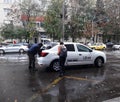 An Uber logo branded car on a street in downtown. White Uber car in traffic, modern city taxi service in Bucharest, Romania, 2019 Royalty Free Stock Photo