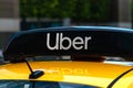 Uber logo icon on top of yellow taxi cab, close up Royalty Free Stock Photo