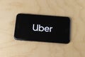 Uber logo on a smartphone. Lyft and Uber ride sharing has replaced many Taxi cabs for transportation