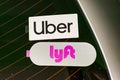 Uber and Lyft emblem on stickers on dusty rear window advertise a vehicle offering sahred rides in Silicon Valley. - San Francisco