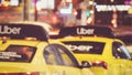 Uber yellow taxi cabs at night, blurry cityscape