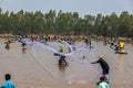 Ubon Ratchathani, Thailand - March 20, 2020 : Many Thai people casting a net for catching fish at river. Fishermen show ancient