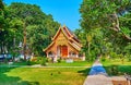 Ubosot of Wat Chiang Man amid green tropic garden, Chiang Mai, Thailand
