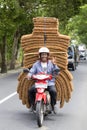 Man is transporting goods on a motorbike on a street in Ubud, island Bali, Indonesia, close up