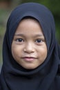 Portrait of a little indonesian muslim girl at the streets in Ubud, island Bali, Indonesia. Close up