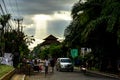 Ubud Bali Street Scene with sunrays and people walking Royalty Free Stock Photo