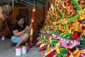 UBUD/INDONESIA-APRIL 27 2019: A female craftsman from Ubud is making dragon carving and coloring it using bright and attractive