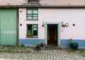 Uccle, Brussels - Belgium -Vintage facade of a brick stone farmers house with a green window in the Fond\' Roy park