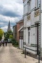 Uccle, Brussels Belgium - Young couple walking the curling Saint Job street with a view over the church tower