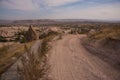 Uchisar, Cappadocia, Turkey: The road leads to the city and Uchisar fortress. Rock houses and churches Royalty Free Stock Photo