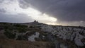 Uchisar Castle view from white valley in Cappadoccia with storm clouds, Turkey Royalty Free Stock Photo