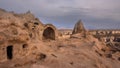 Uchisar with residential dwellings in caves, Cappadocia Turkey on sunset Royalty Free Stock Photo