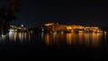 Udaipur cityscape by night. The majestic city palace reflecting lights on Lake Pichola, travel destination in Rajasthan, India. Royalty Free Stock Photo