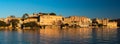 Udaipur cityscape at sunset. The majestic city palace on Lake Pichola, travel destination in Rajasthan, India Royalty Free Stock Photo