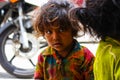 Udaipur, India - August 20, 2009: Indian girl with an intense gaze asks for alms with her sister in Udaipur, India Royalty Free Stock Photo