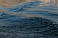 WAVES CREATED BY A BOAT IN LAKE WATERS