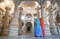 Udaipur, Rajasthan, India - February 23 2020: Indian wearing sari in Jain Ranakpur Temple marble stone carve, Udaipur, Rajasthan,