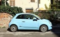 Light blue new Fiat 500 car parked in an urban road. Side view. Royalty Free Stock Photo