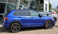 Blue Volkswagen Tiguan, compact crossover suv of the german automaker, on display outside the official dealership.