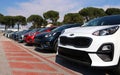 Kia car models lined up outside the local dealership of a korean automaker company.