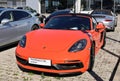 Orange colored Porsche 718 Boxster GTS 4.0 on display outside the official dealership