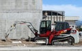 Brand new Takeuchi mini excavator and mini bulldozer at work in a construction site Royalty Free Stock Photo