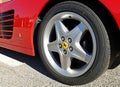 Ferrari logo on the rear car rim of a sports car of italian automaker. Hereinafter Pininfarina logo on the red body Royalty Free Stock Photo