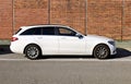 White Mercedes Benz Class C station wagon. Side view on brick wall background Royalty Free Stock Photo