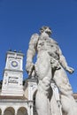 Udine, statue of Hercules with clock tower Royalty Free Stock Photo